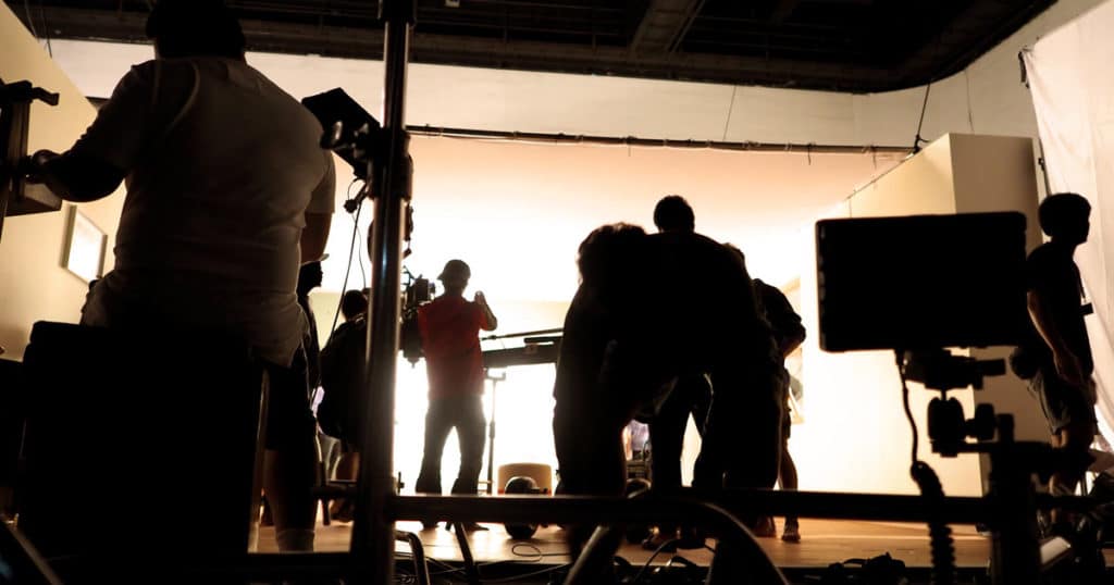Video production crew in silhouette